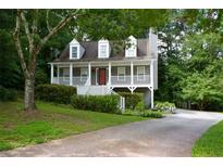 Charming home with a welcoming front porch and landscaped front yard at 55 Legend Creek Cv, Douglasville, GA 30134