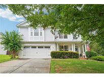 Charming two-story home with a well-manicured lawn and inviting front porch at 233 Hampton Station Blvd, Canton, GA 30115