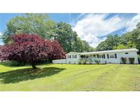 Charming one-story brick home with a spacious front yard and inviting covered porch at 1035 Cornish Mountain Church Rd, Oxford, GA 30054