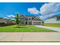 Inviting two-story home with a well-manicured lawn and attractive exterior finishes at 146 Himalaya Way, Mcdonough, GA 30253
