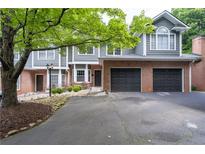 Charming townhome with brick accents, attached garages, well-kept landscaping and inviting curb appeal at 2680 Pine Tree Ne Rd # 2, Atlanta, GA 30324