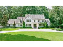 Beautiful two-story traditional style home with a well-manicured lawn and circular driveway at 510 Heards Ferry Rd, Atlanta, GA 30328