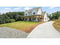 Stunning two-story modern farmhouse with a welcoming porch and well-manicured lawn at 5315 Hendrix Rd, Cumming, GA 30040
