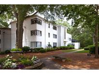 Beautiful exterior view of this home with white brick, black framed windows, and professionally landscaped grounds at 1120 Briarcliff Ne Rd # 5, Atlanta, GA 30306