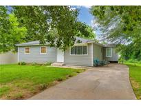 Charming single-story home with a well-maintained lawn, siding, and a cozy seating area on the driveway at 2199 Clairmont Cir, Snellville, GA 30078