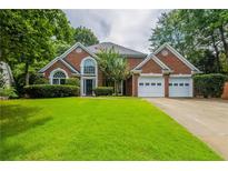 Charming two-story brick home with a well-manicured lawn and an attached two-car garage at 3807 Lance Bluff Ct, Duluth, GA 30097