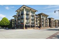 Modern condo building featuring balconies, street-level retail, and a contemporary design at 5300 Peachtree Rd # 2309, Chamblee, GA 30341