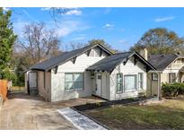 Charming home featuring a brick facade, black trim, and a landscaped yard with a new walkway at 2128 Hosea L Williams Ne Dr, Atlanta, GA 30317