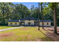Inviting single Gathering home with spacious front yard and lush, mature trees offering shade and privacy at 2023 Stoneleigh Dr, Stone Mountain, GA 30087