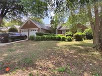 Charming brick home featuring an attached two-car garage and mature landscaping at 3587 Plum Creek Nw Trl, Kennesaw, GA 30152