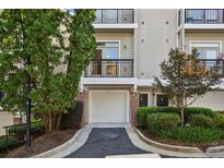 Charming condo exterior features a private balcony, one-car garage, and lush landscaping at 4254 River Green Dr # 613, Atlanta, GA 30327
