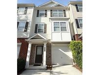Charming townhouse featuring a brick facade, attached garage, and a welcoming entrance at 6817 Blackstone Pl # 16, Mableton, GA 30126