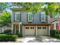 Charming two-story home features a two-car garage, complemented by lush greenery and a welcoming entrance at 2412 St Davids Sq # 16, Kennesaw, GA 30152