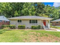 Charming single-story home featuring a well-manicured lawn, brick accents, and a welcoming red front door at 793 Springdale Sw, Atlanta, GA 30315