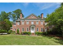 Beautiful brick two-story home featuring a manicured lawn and mature landscaping at 2671 Bohler Nw Rd, Atlanta, GA 30327