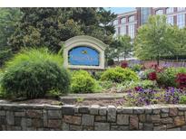 Landscaped entrance sign for Vinings View Condominiums with stone base, lush greenery and colorful flowers at 3160 Seven Pines Unit 105 Ct, Atlanta, GA 30339
