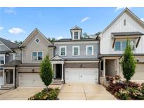 Charming townhome featuring a two-car garage and craftsman-style architectural details at 402 Retreat Ln, Canton, GA 30114