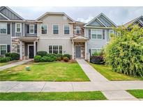 Charming townhomes featuring manicured lawns and welcoming entrances at 235 Orchard Dr, Covington, GA 30014