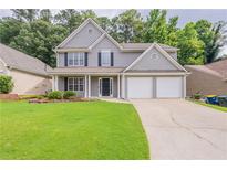 Charming gray two-story home with a well-manicured lawn and a two-car garage at 4271 Brighton Nw Way, Kennesaw, GA 30144