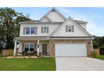 Charming two-story home featuring a stone-accented facade, a two-car garage, and a well-manicured lawn at 437 Autrey Dr, Douglasville, GA 30134