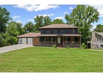 Charming two-story home with a welcoming front porch and lush green lawn at 5254 Greenpoint Drive, Stone Mountain, GA 30088