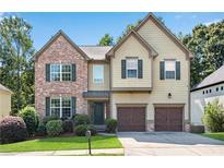 Charming two-story home featuring a brick facade, green shutters, and a well-manicured lawn at 5688 Baffin Rd, Atlanta, GA 30349