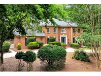Beautiful two-story brick home featuring a well-manicured lawn and lush, mature landscaping for added privacy at 1320 Northcliff Trce, Roswell, GA 30076