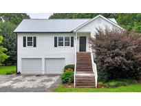 Charming two-story home with white siding, black shutters, and a welcoming staircase at 33 Moriah Ne Way, Rydal, GA 30171