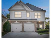 Charming two-story home featuring a two-car garage, complemented by lush landscaping at 296 Water Oak Pl, Alpharetta, GA 30009