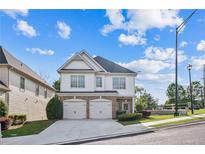 Charming two-story home featuring a brick and siding facade, a two-car garage, and a well-maintained front yard at 296 Water Oak Pl, Alpharetta, GA 30009