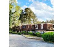 View of a multi-Gathering residential building with brown roofs and manicured green shrubbery at 2972 Parc Lorraine, Lithonia, GA 30038