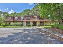 Inviting condo complex with mature trees, manicured landscaping, and ample parking at 2972 Parc Lorraine, Lithonia, GA 30038