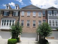 Attractive townhome features brick facade, garage, manicured landscaping and plenty of natural light at 2975 Wintercrest Trce, Dunwoody, GA 30360