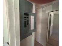 Image shows an electrical panel with open door on a wall; electrical components visible at 4601 Wilson James Rd, Atlanta, GA 30331