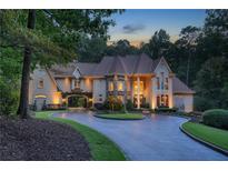 Elegant estate with circular drive, porte-cochere, lush landscaping, and stone accents at 1500 Historic Vw, Stone Mountain, GA 30087