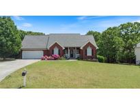 Charming brick home features a well-manicured lawn and colorful flower beds at 20 Friendship Rd, Euharlee, GA 30145