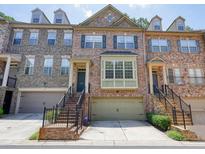 Charming brick townhome featuring an attached two-car garage and a welcoming front entrance with brick stairs at 2774 Birch Grove Se Ln # 11, Marietta, GA 30067