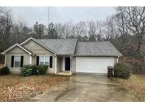 Cozy single-story home with a well-maintained lawn and a two-car garage at 504 Edgewood Trce, Mcdonough, GA 30253