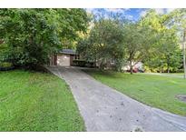 Charming home with a long driveway and lush green lawn at 4039 Tanglewood Rd, Snellville, GA 30039