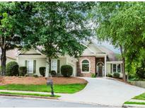 Charming one-story home with stone accents, manicured lawn and mature trees at 1122 Cayuga Ct, Dacula, GA 30019