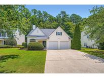 Charming traditional home featuring a well-manicured lawn and a two-car garage at 181 Weatherstone Dr, Woodstock, GA 30188