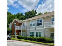 Inviting exterior featuring manicured landscaping, private balconies, and assigned parking spaces at 1428 Orchard Park Dr, Stone Mountain, GA 30083