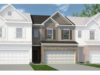 New construction townhome featuring a brick and siding exterior with attached two-car garage at 18 Jacobs Farm Ln # 9, Lawrenceville, GA 30045