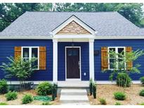 Charming blue home with a welcoming front door, white columns and light wood accents at 2625 Semmes St, Atlanta, GA 30344
