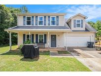 Charming two-story home with a covered front porch and a well-maintained lawn at 45 Ratliff Dr, Covington, GA 30016
