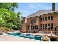Stunning backyard with pool, spa, fire pit and large deck for entertaining with lots of privacy at 908 Basingstoke Ct, Suwanee, GA 30024