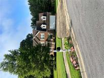 Charming brick home boasts a two-car garage and a beautifully landscaped front yard, offering great curb appeal at 978 Francis Ln, Fairburn, GA 30213
