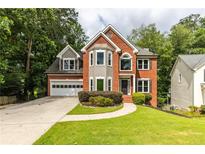 Charming two-story brick home with a well-manicured front lawn and attached two-car garage at 1612 Branch Creek Cv, Lawrenceville, GA 30043