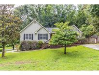 Charming home with a well-manicured lawn, mature trees, and a cozy front porch at 10 Mariner Se Way, Acworth, GA 30102