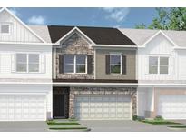 Beautiful townhouse with stone and siding exterior, a garage, and manicured landscaping at 100 Jacobs Farm Ln # 39, Lawrenceville, GA 30045